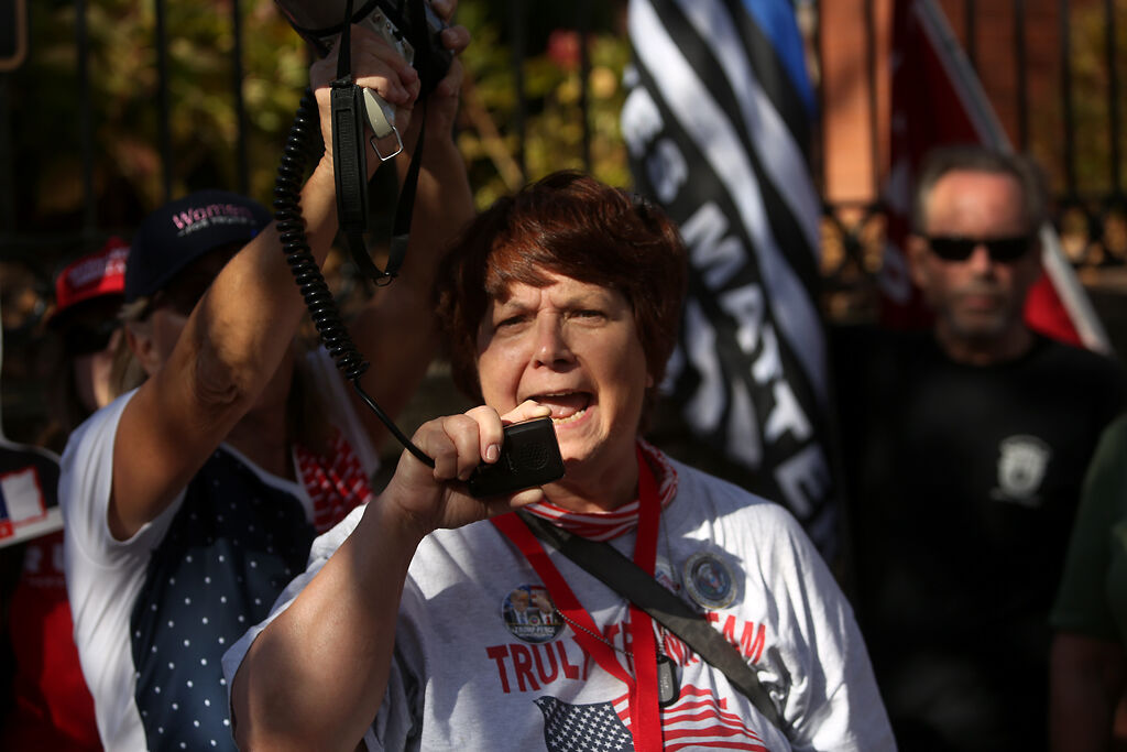 Brenda Webb from the St. Charles County Truly Trump Team speaks through a megaphone